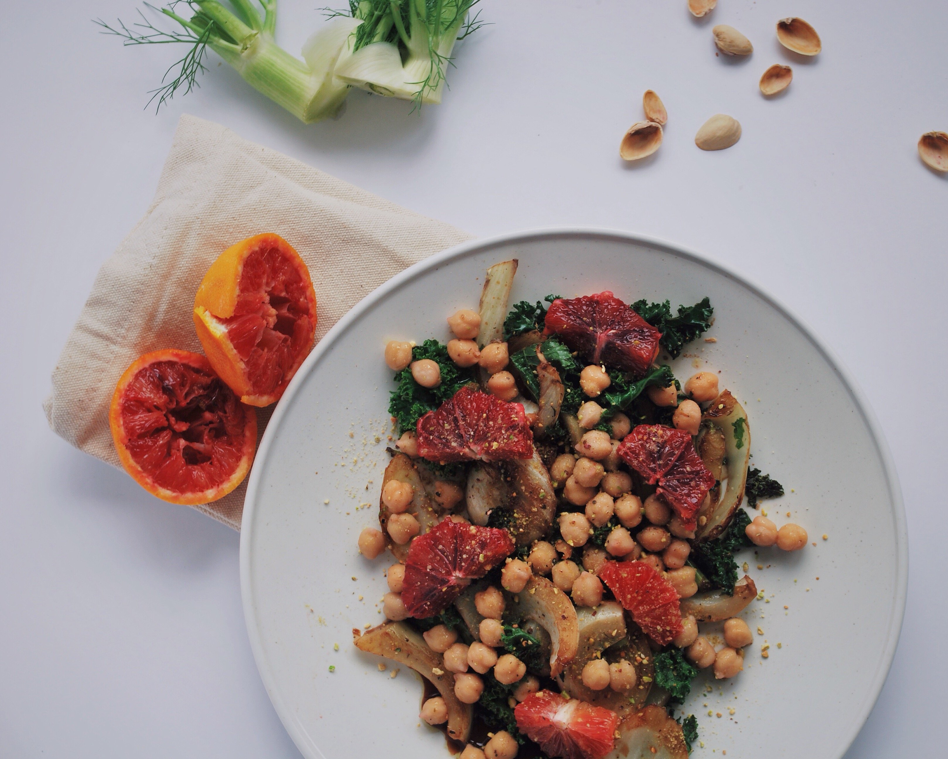 Winter Abundance Salad: All of winter's finest resting on one beautiful plate! This vegan and gluten free delight is full of vitamins and exquisite tastes that will leave you pining for more! Fennel, blood oranges, kale, pistachios, and chickpeas make up this wonderful dish! || fooduzzi.com