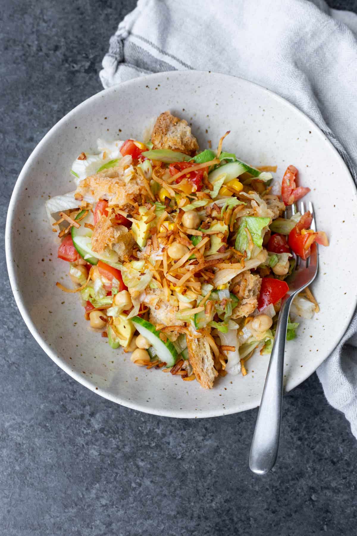 A vegan panzanella salad in a light bowl