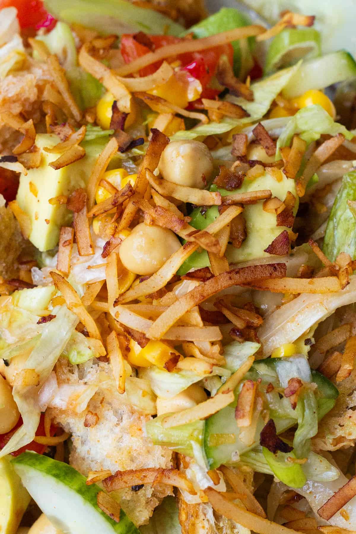 A close-up of a vegan panzanella salad in a light bowl