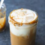 a cookie butter iced coffee with vanilla oatmilk cold foam in a mason jar