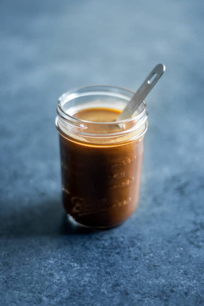 a spoon in a jar of balsamic vinaigrette