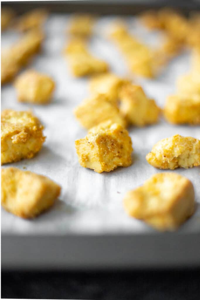 baked crispy tofu nuggets on a baking sheet