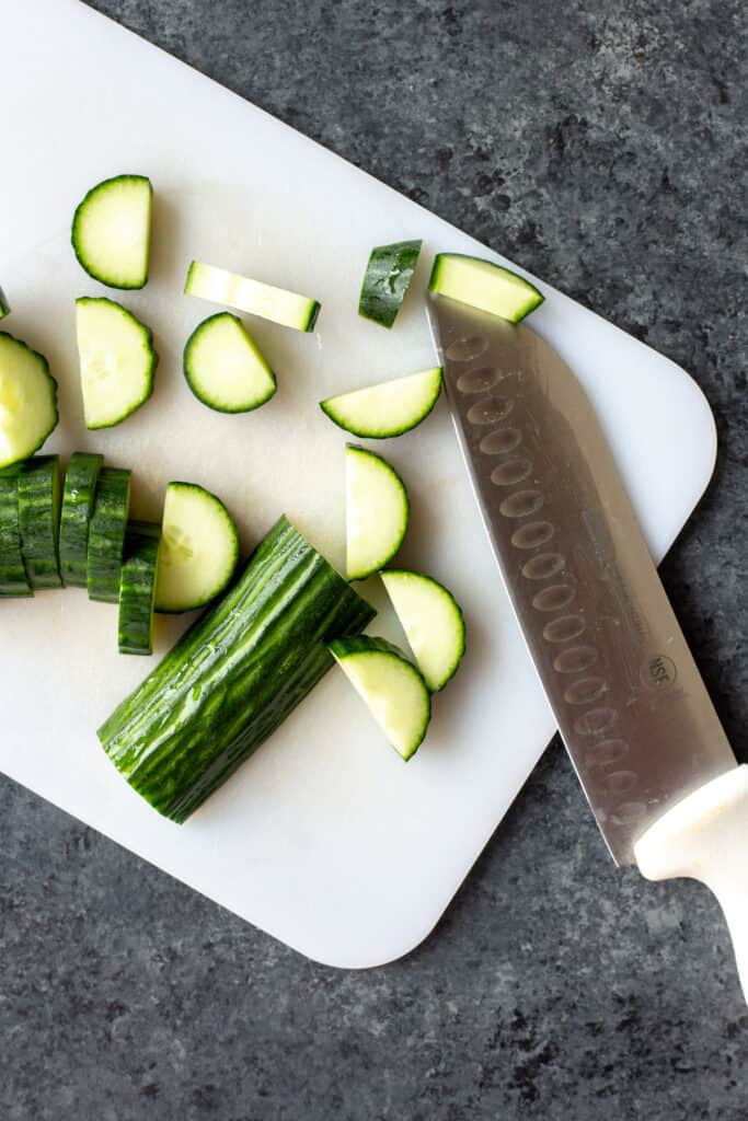 a sliced avocado on a cutting board with a knife