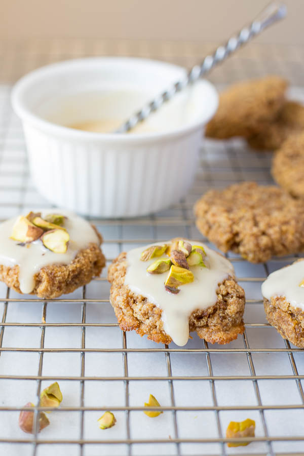 Chewy Lemon Cookies with Coconut Icing and Pistachios: a healthy, gluten free, and vegan cookie that's incredibly chewy and full of fresh flavors! This recipe is refined sugar-free! || fooduzzi.com recipe