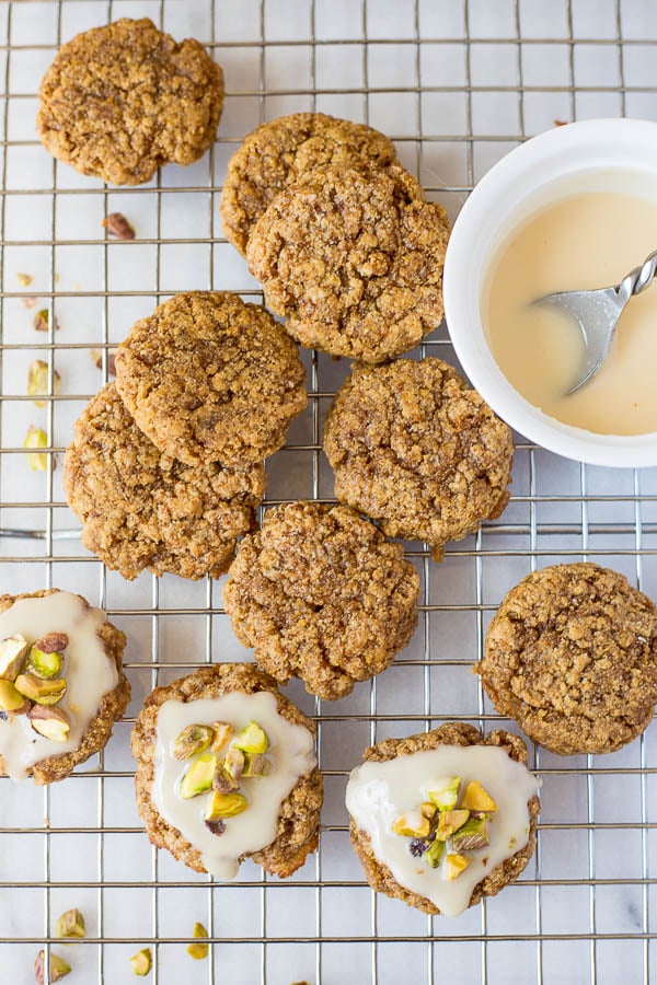 Chewy Lemon Cookies with Coconut Icing and Pistachios: a healthy, gluten free, and vegan cookie that's incredibly chewy and full of fresh flavors! This recipe is refined sugar-free! || fooduzzi.com recipe