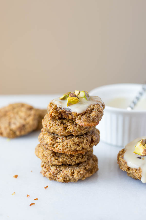 Chewy Lemon Cookies with Coconut Icing and Pistachios: a healthy, gluten free, and vegan cookie that's incredibly chewy and full of fresh flavors! This recipe is refined sugar-free! || fooduzzi.com recipe