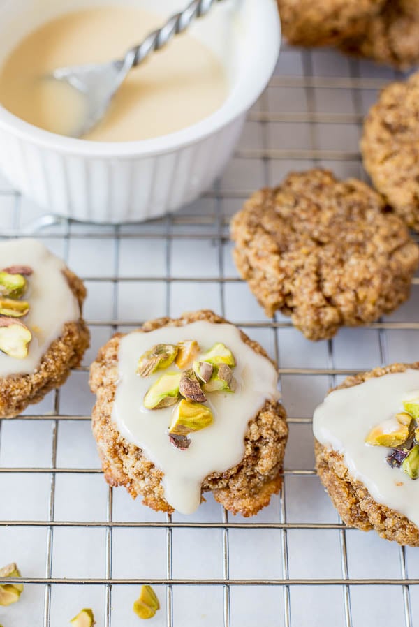 Chewy Lemon Cookies with Coconut Icing and Pistachios: a healthy, gluten free, and vegan cookie that's incredibly chewy and full of fresh flavors! This recipe is refined sugar-free! || fooduzzi.com recipe