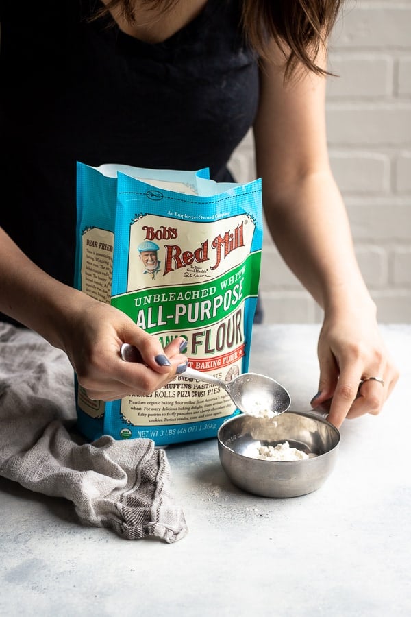 measuring bob's red mill organic all-purpose flour for soft pretzels