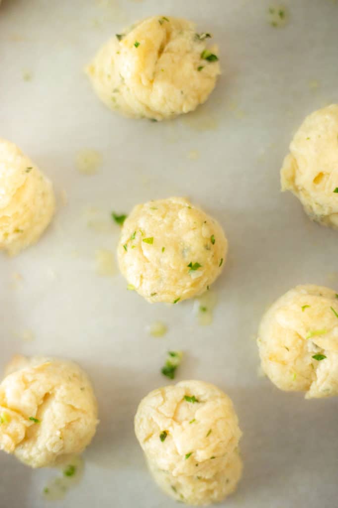 mini vegan herb biscuits on a baking sheet