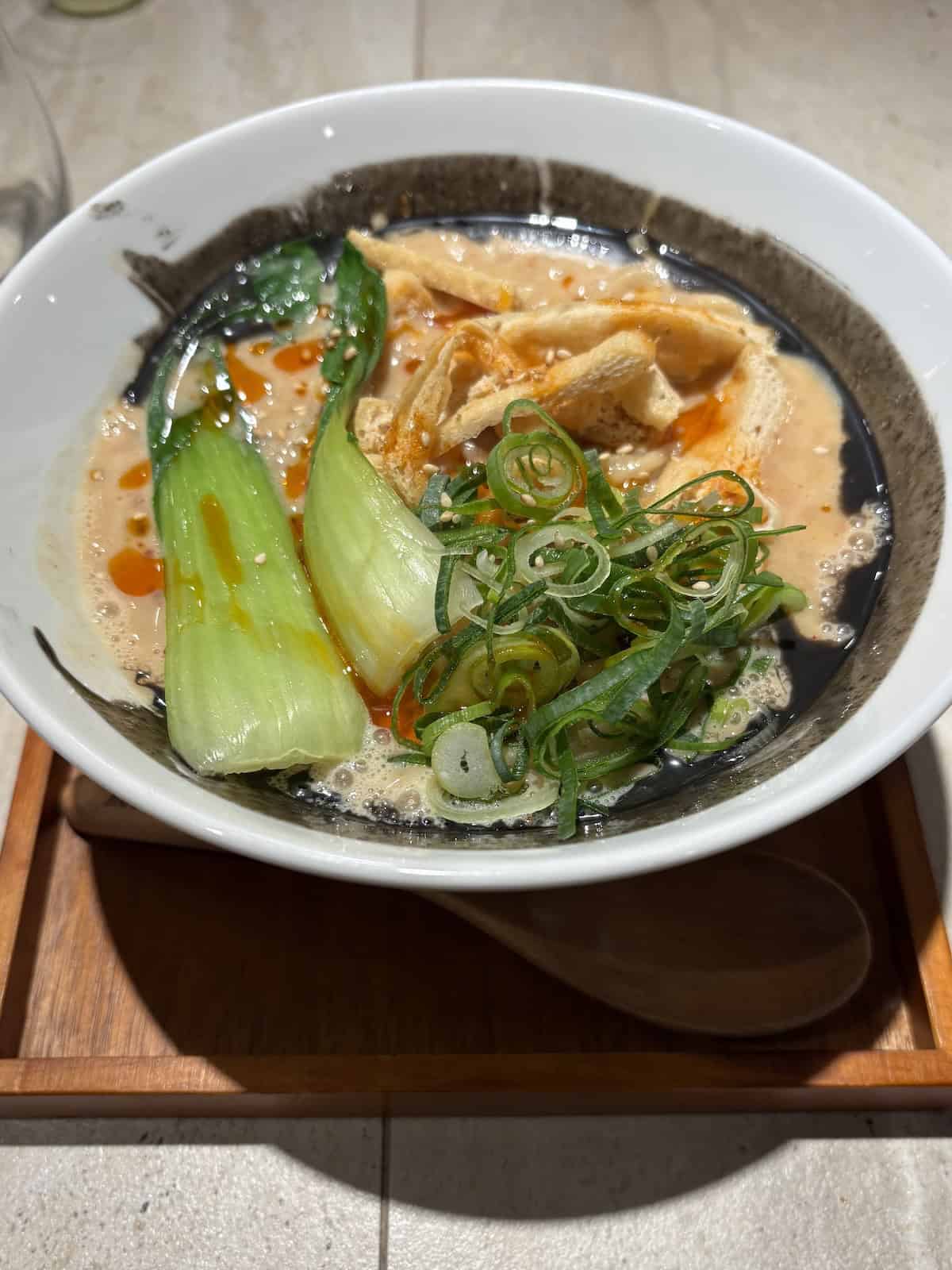 Vegan ramen from Moon and Back in Kyoto topped with fried tofu, bok choy, and green onion