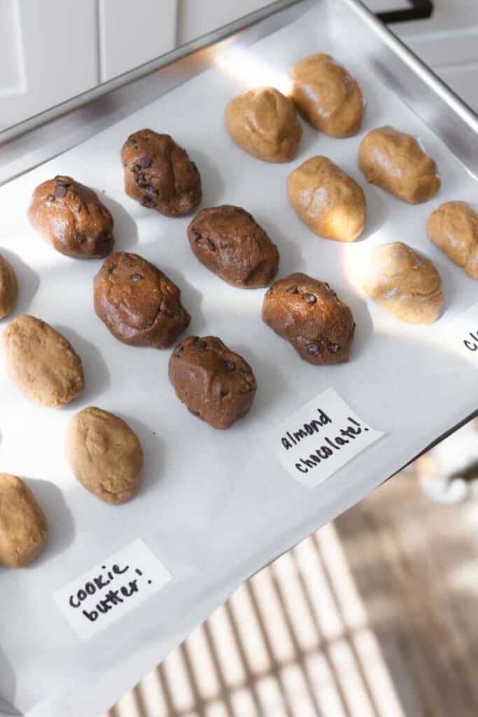 cookie butter, almond chocolate, and classic vegan peanut butter eggs on a parchment-lined baking sheet