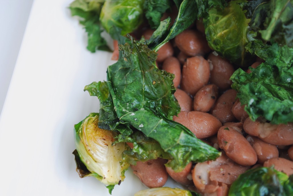 Kale & Pinto Beans: Crispy kale, creamy pinto beans, and sweet roasted brussels make up this play on a restaurant favorite! Filled with protein and vitamins, this healthy gluten free and vegan entrée is sure to satisfy! || fooduzzi.com