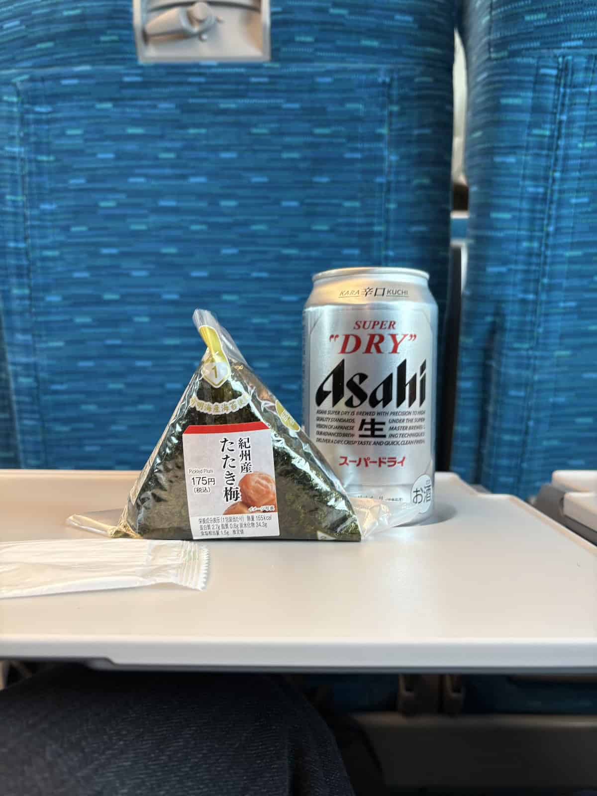 A pickled plum onigiri and a can of Asahi super dry