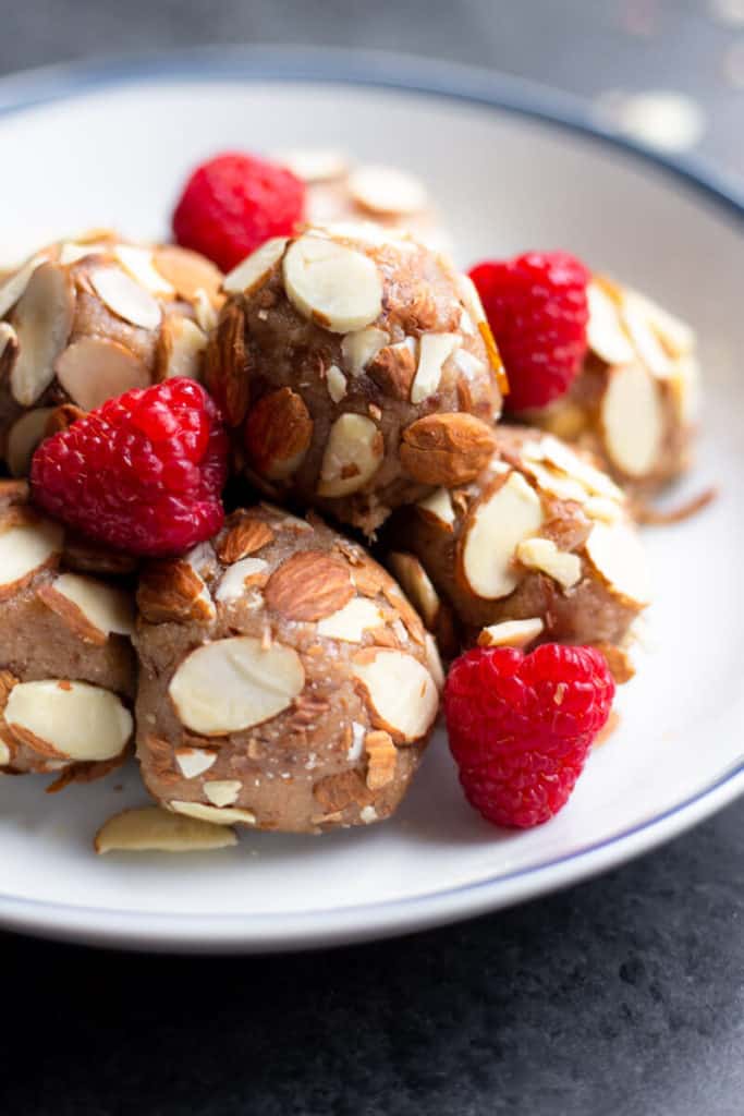 A bowl of stacked Raspberry Almond Date Truffles