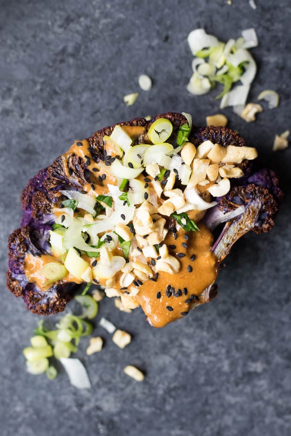 Thai Peanut Cauliflower Steaks: A quick and easy dinner recipe that's sure to satisfy! Serve with quinoa, zucchini noodles, rice, or other roasted veggies for a delicious and filling vegan and gluten free dinner! || fooduzzi.com recipe