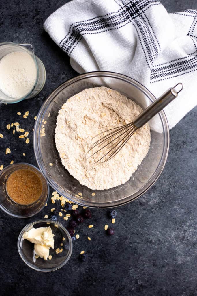 a bowl of flour with a whisk sticking out of it