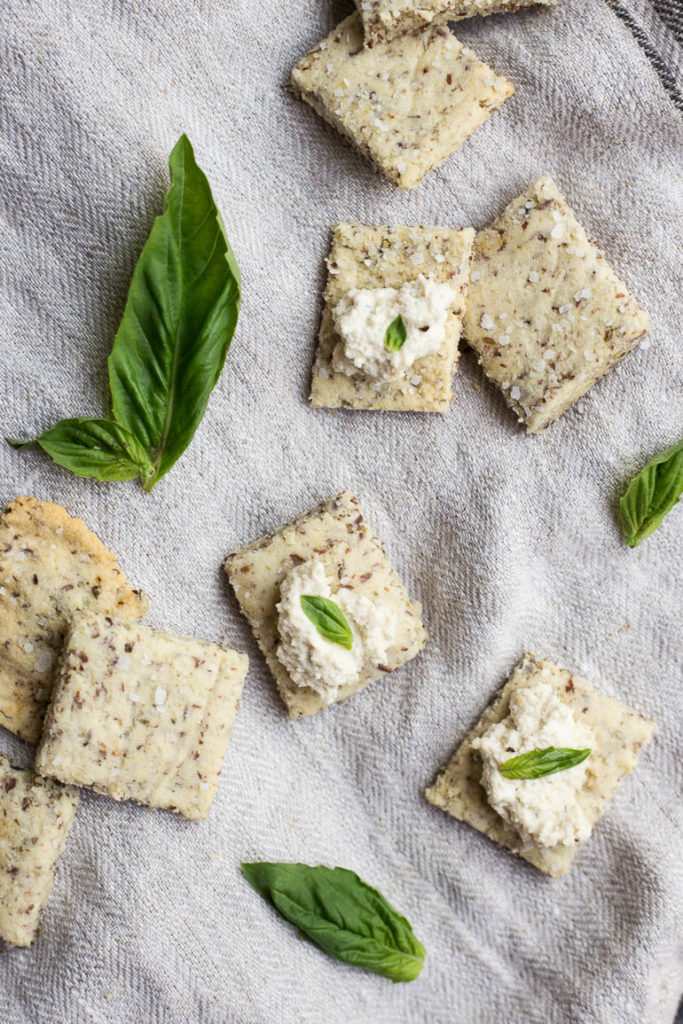 Vegan Garlic Herb Almond Flour Crackers: Make crunchy, delicious crackers at home in 30 minutes! Naturally gluten free and vegan, and super simple to make! || fooduzzi.com recipe