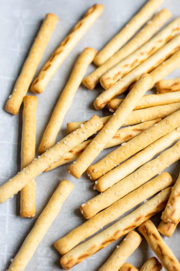 a bunch of pretzel sticks on a baking sheet