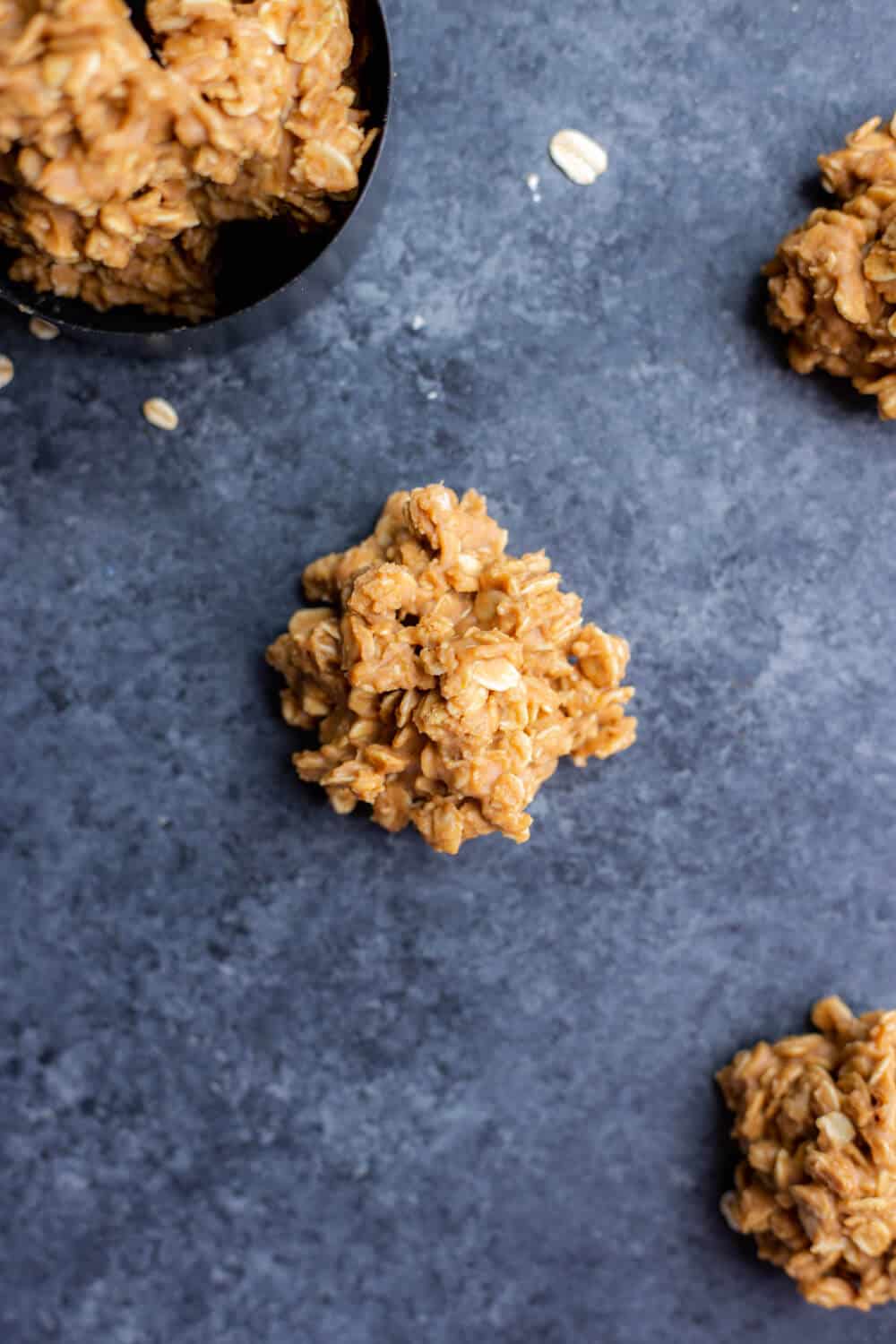 a few vegan cookie butter no-bake cookies on a dark background