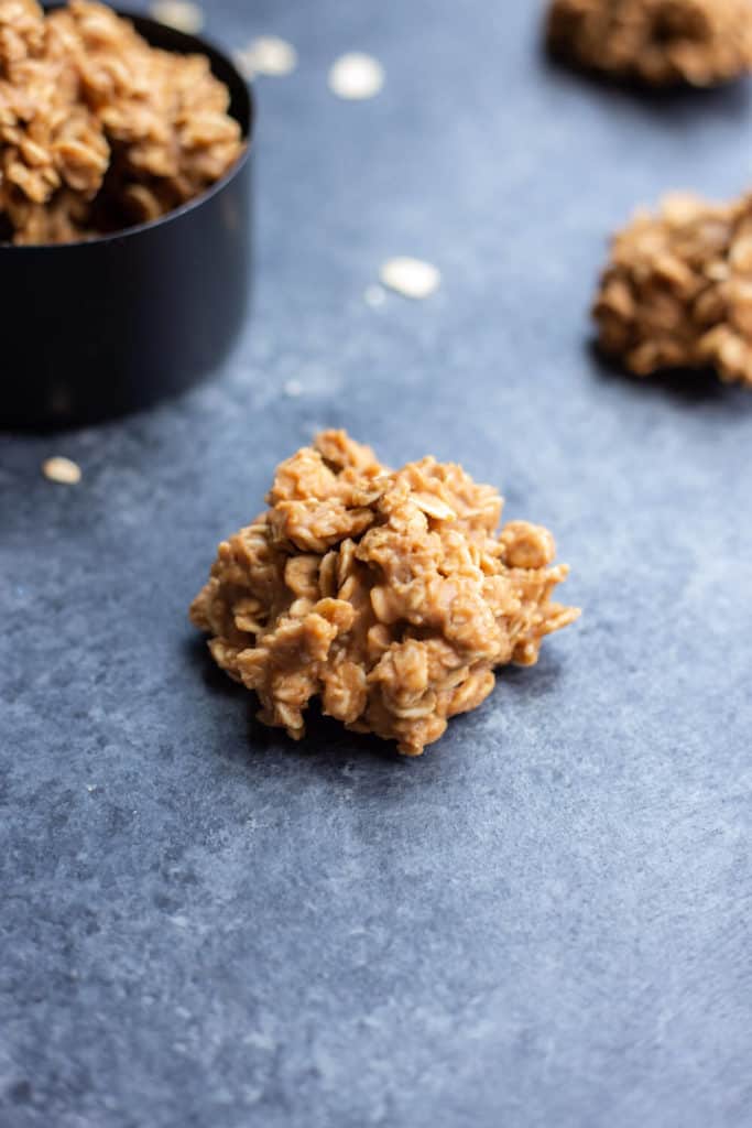 a few vegan cookie butter no-bake cookies on a dark background