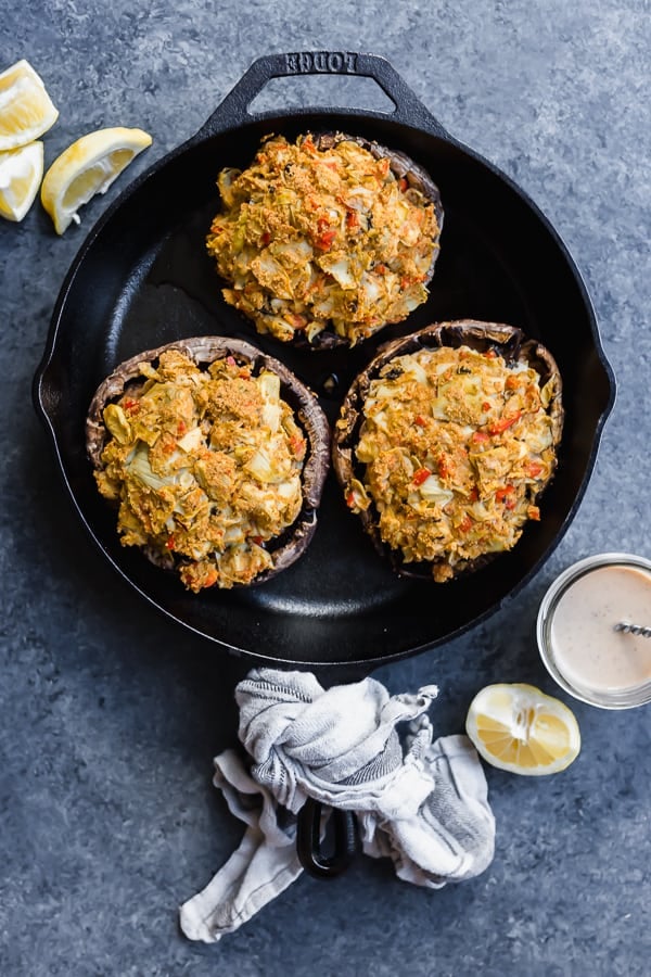 vegan crab cake-stuffed portobello mushrooms in a cast-iron skillet