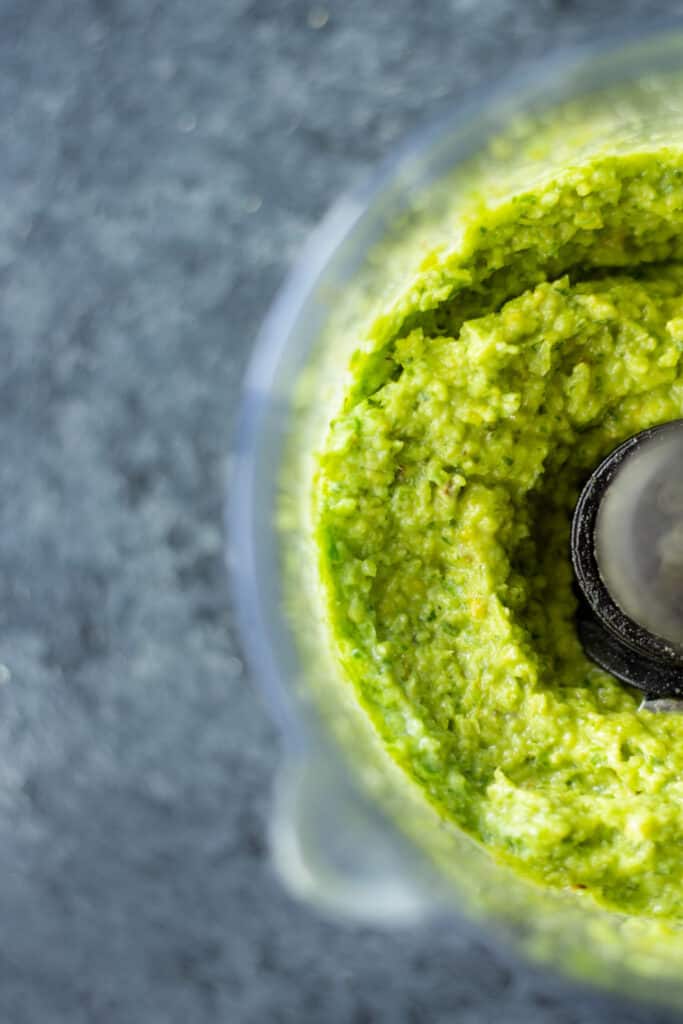 a vegan garlic scape pesto in a food processor