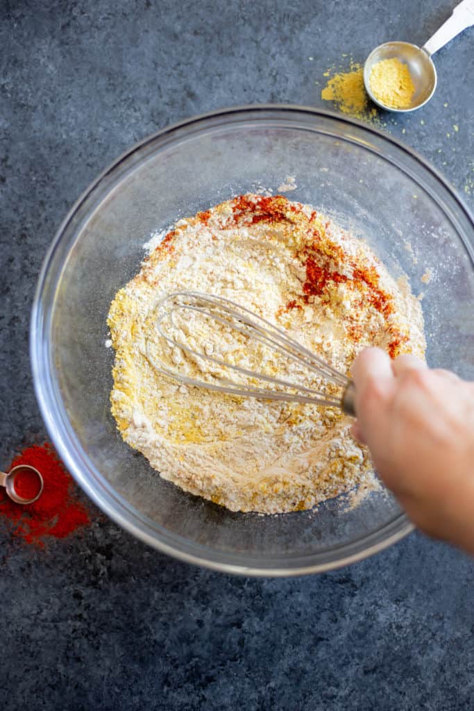 vital wheat gluten and seasonings being whisked in a bowl