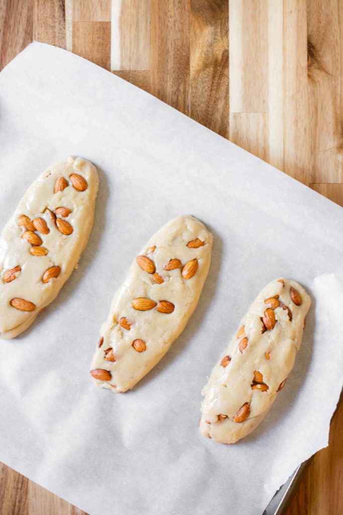 unbaked vegan lemon biscotti logs on a baking rack