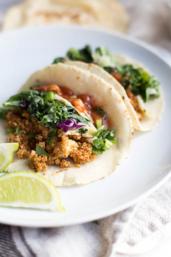 two vegan tacos with kale slaw and tofu quinoa taco meat on a plate